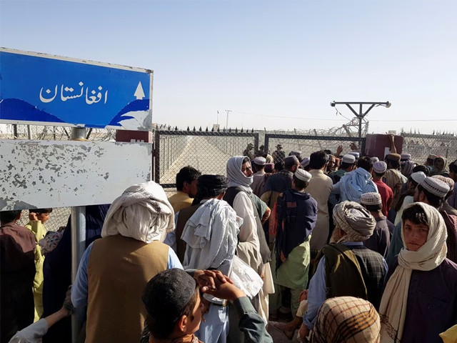 people gather as they wait to cross at the friendship gate crossing point in the pakistan afghanistan border town of chaman pakistan august 12 2021 photo reuters