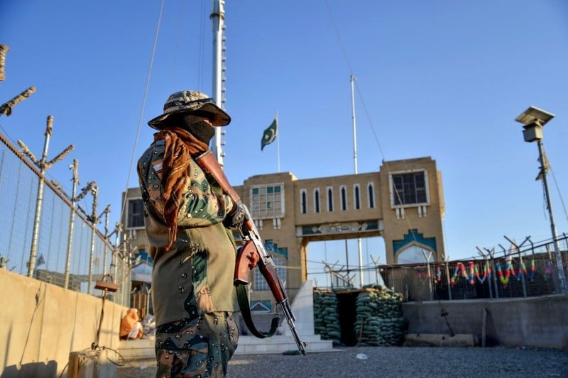 afghan security stands guard at a fenced corridor of the afghanistan pakistan border in spin boldak afghanistan on december 3 2023 photo afp