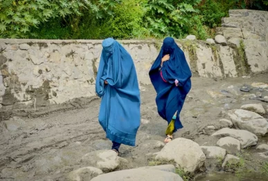 afghan women in burqa walk towards a safer place after their house was damaged following a deadly magnitude 6 earthquake that struck afghanistan on sunday at lulam village in nurgal district kunar province afghanistan september 3 2025 photo reuters
