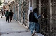 afghan men walk past shops closed in solidarity with victims of an attack by unidentified armed men on the outskirts of the sayed mohammad agha shia shrine photo afp
