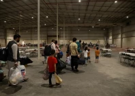 special immigrants from afghanistan walk through the in processing building after their evacuation at camp as sayliyah qatar august 20 2021 u s army sgt jimmie baker handout via reuters