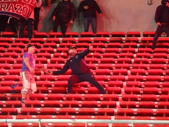 a fan of universidad de chile throws a stone during the copa sudamericana match against independiente at the libertadores de america stadium in avellaneda buenos aires argentina on wednesday