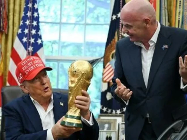 us president donald trump alongside fifa president gianni infantino holds the world cup trophy in the oval office us president donald trump alongside fifa president gianni infantino holds the world cup trophy in the oval office