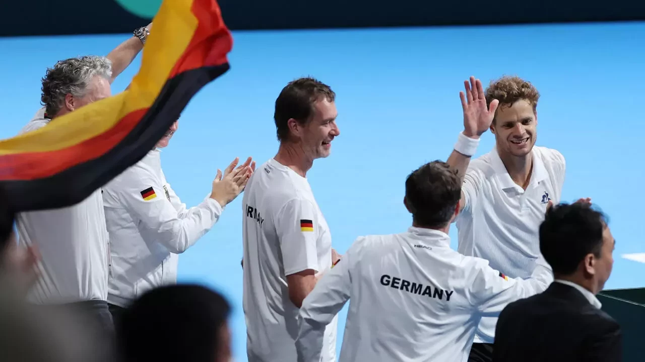 germany s yannick hanfmann top r celebrates with teammates after his victory over japan s shintaro mochizuki in davis cup second round qualifiers photo afp