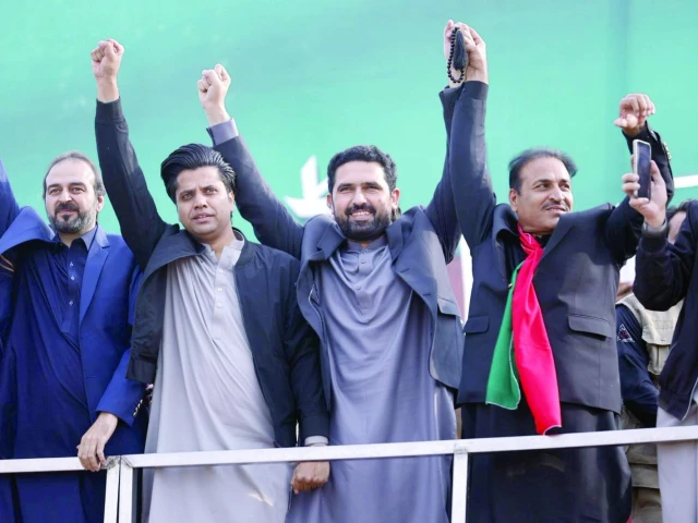 k p chief minister sohail afridi and other party leaders raise hands as they arrive for a pti rally in kohat photo express k p chief minister sohail afridi and other party leaders raise hands as they arrive for a pti rally in kohat photo express