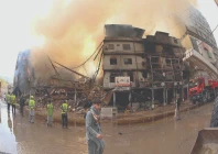 smoke billows from karachi s gul plaza following a massive fire photo inp
