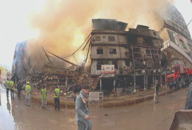 smoke billows from karachi s gul plaza following a massive fire photo inp