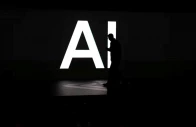 a screen reads ai in reference to artificial intelligence as attendees gather during rivian s first autonomy and ai day showcasing developments in self driving technology in palo alto california us december 11 2025 reuters