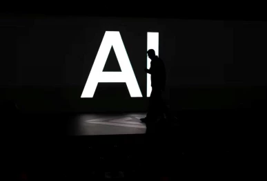 a screen reads ai in reference to artificial intelligence as attendees gather during rivian s first autonomy and ai day showcasing developments in self driving technology in palo alto california us december 11 2025 reuters