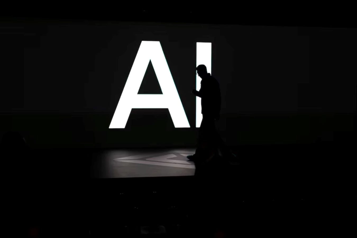 a screen reads ai in reference to artificial intelligence as attendees gather during rivian s first autonomy and ai day showcasing developments in self driving technology in palo alto california us december 11 2025 reuters