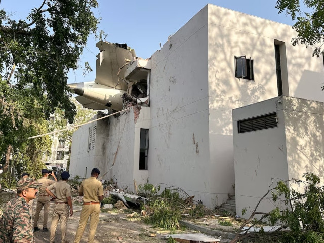 A tail of an Air India Boeing 787 Dreamliner plane that crashed is seen stuck on a building after the incident in Ahmedabad, India, June 12, 2025. Photo: Reuters
