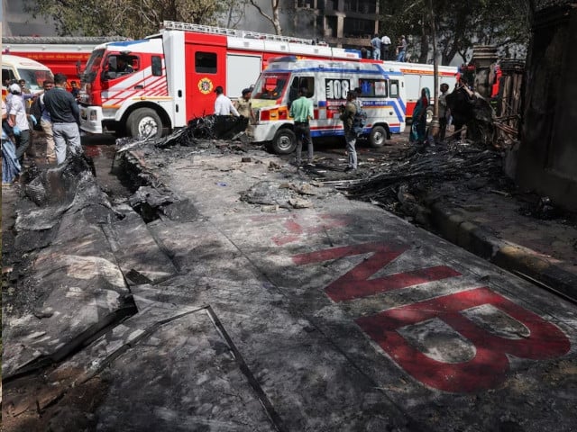 Wreckage of a Boeing 787 Dreamliner lies at the site, showing part of its registration 