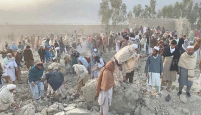 afghan men gather at the site of an overnight air strike in girdi kas village of bihsud district of nangarhar province photo afp