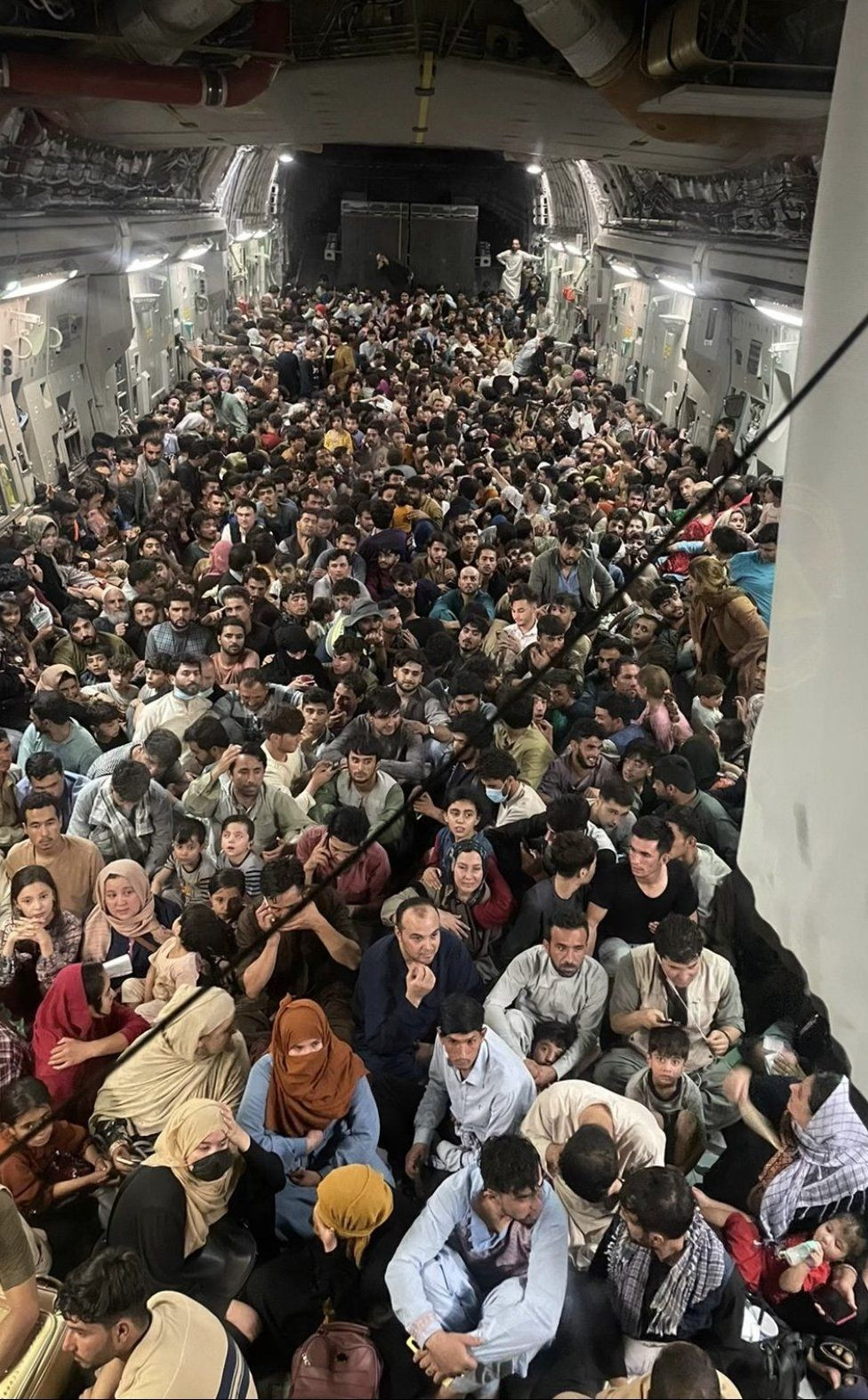 Hundreds of Afghans packed into a US military cargo plane as they flee Kabul. Photo: US Air Mobility Command