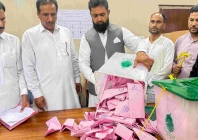 a polling officer opens a ballot box for counting at a polling station during the first phase of voting for the local legislature in mirpur on july 27 2026 photo afp