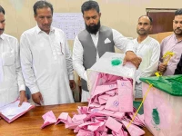 a polling officer opens a ballot box for counting at a polling station during the first phase of voting for the local legislature in mirpur on july 27 2026 photo afp