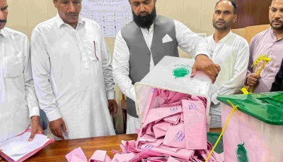 a polling officer opens a ballot box for counting at a polling station during the first phase of voting for the local legislature in mirpur on july 27 2026 photo afp
