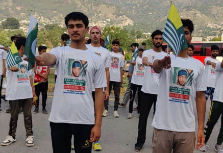 young kashmiris hold pakistan and azad jammu and kashmir flags at a rally commemorating burhan wani photo express