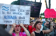 protesters hold banners during a protest against a luxury resort development planned by a company linked with donald trump s son in law jared kushner on an environmentally sensitive part of the adriatic coast in tirana albania on june 4 2026 photo reuters