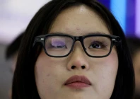 a woman tries on a pair of quark ai glasses by alibaba at the company s booth at the expo of the world internet conference in wuzhen town of tongxiang city zhejiang province china november 8 2025 photo reuters