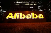 the logo of alibaba group is lit up at its office building in beijing china august 9 2021 reuters