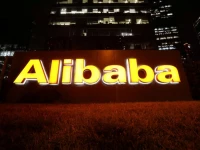 the logo of alibaba group is lit up at its office building in beijing china august 9 2021 reuters