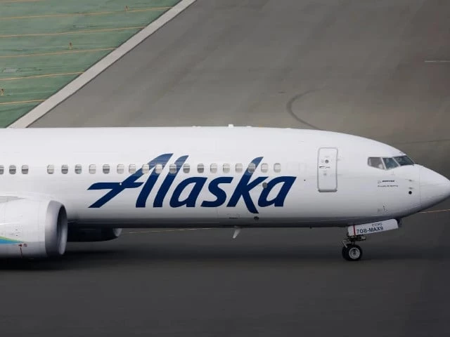 new video shows alaska airlines passenger opening emergency exit climbing onto plane wing in seattle