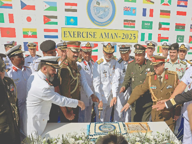 commander of pakistan fleet rear admiral abdul munib along with naval commanding officers of participating countries cut a cake during the opening ceremony of pakistan navy s 9th multinational maritime exercise aman 25 photo reuters