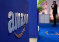 a visitor stands near a logo of amazon during the annual retail leadership summit in mumbai india february 27 2025 photo reuters