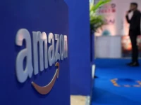 a visitor stands near a logo of amazon during the annual retail leadership summit in mumbai india february 27 2025 photo reuters