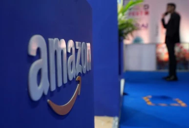 a visitor stands near a logo of amazon during the annual retail leadership summit in mumbai india february 27 2025 photo reuters