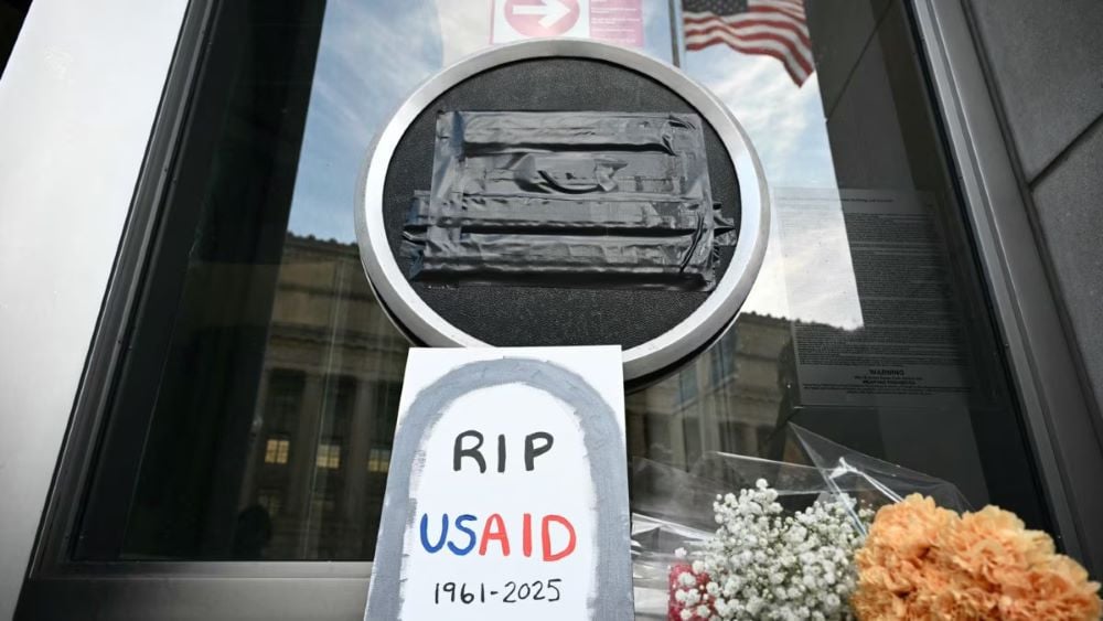 rip sign and flowers at the usaid headquarter building photo afp