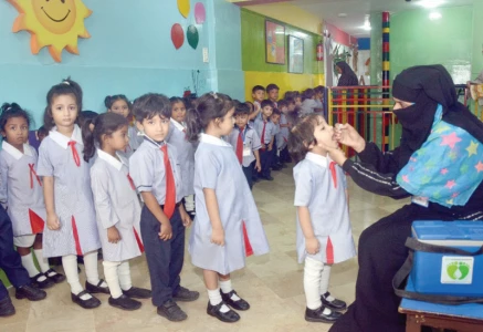 a female health worker administers anti polio drops to a student at a montessori in the saddar area during polio vaccination drive in october 2025 photo jalal qureshi express