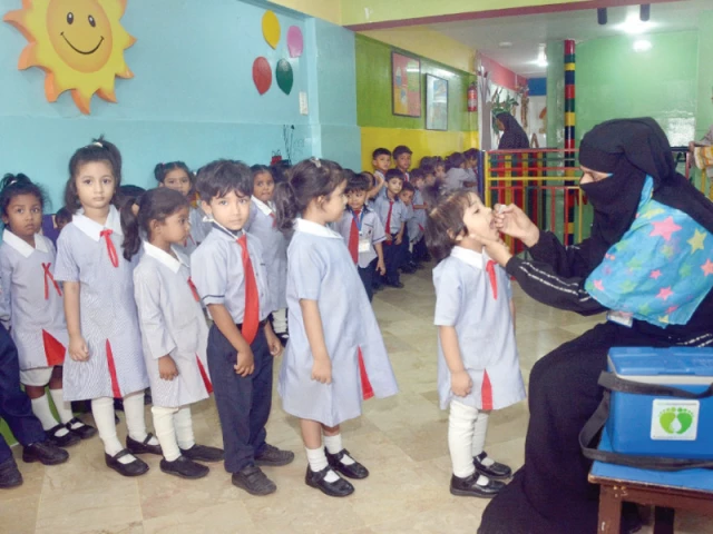 a female health worker administers anti polio drops to a student at a montessori in the saddar area as part of the polio vaccination drive inaugurated on monday photo jalal qureshi express