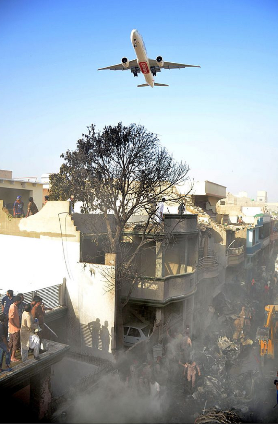 A view of rescue operations as a Pakistan International Airlines (PIA) passenger flight PK-303 carrying 91 passengers and eight crew members crashed near the Jinnah International Airport just before landing. PHOTO: APP