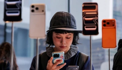a woman uses her smartphone inside the apple store in beijing s sanlitun area as the iphone 17 series smartphones go on sale in beijing china september 19 2025 photo reuters