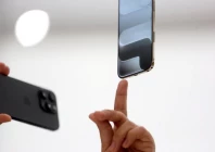 a person points to an iphone during apple s event at the steve jobs theater on its campus in cupertino california u s september 9 2025 reuters