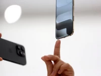 a person points to an iphone during apple s event at the steve jobs theater on its campus in cupertino california u s september 9 2025 reuters