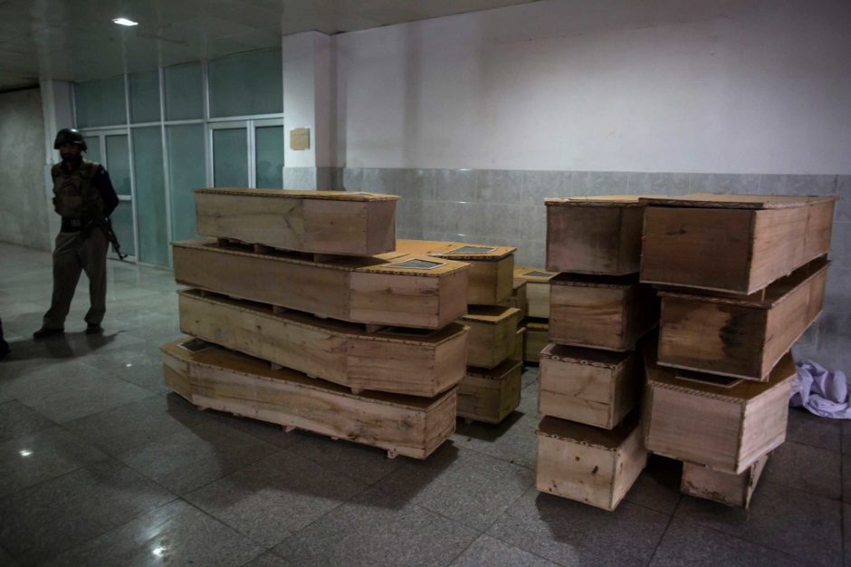 A policeman stands beside empty coffins at the hospital after an attack by Taliban gunmen on the Army Public School in Peshawar December 16, 2014. PHOTO: REUTERS