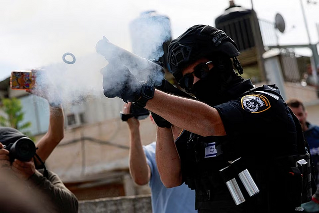 An Israeli border police officer fires a crowd-control gas canister, as Muslim Palestinians try to hold Friday prayers by a road outside the Old City of Jerusalem, while the conflict between Israel and Hamas continues, in Jerusalem, October 27, 2023. PHOTO: REUTERS