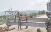 pak army core of engineers personnel work to restore a bridge linking bajaur and dir photo express