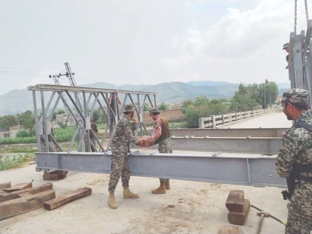 pak army core of engineers personnel work to restore a bridge linking bajaur and dir photo express