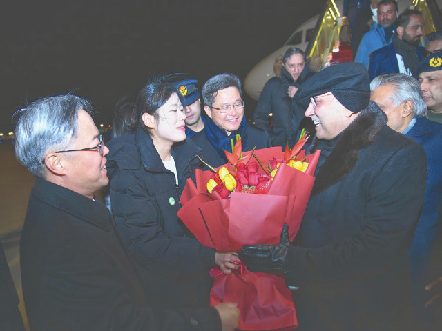 president asif ali zardari receives a flower bouquet upon arrival in beijing photo app