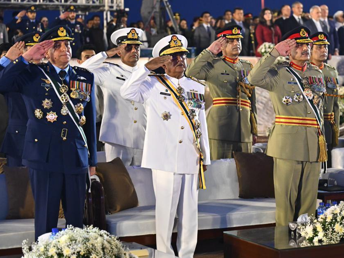 Chief of Defence Forces Field Marshal Asim Munir, Air Chief Marshal Zaheer Ahmed Babar Sidhu and Chief of Naval Staff Admiral Naveed Ashraf stand in honour of the national anthem during the Marka-e-Haq first anniversary ceremony at the Pakistan Monument in Islamabad. Photo: PID