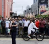 a police officer gestures as people gather outside angullia mosque to wait for the body of sharif osman hadi a bangladeshi student leader who died following a fatal shooting in dhaka in singapore december 19 2025 source reuters
