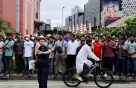 a police officer gestures as people gather outside angullia mosque to wait for the body of sharif osman hadi a bangladeshi student leader who died following a fatal shooting in dhaka in singapore december 19 2025 source reuters