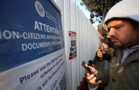 migrants check their phones while gathering at el chaparral border crossing after their cbp one app asylum appointment was cancelled on the day of u s president donald trump s inauguration in tijuana mexico january 20 2025 reuters