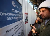 migrants check their phones while gathering at el chaparral border crossing after their cbp one app asylum appointment was cancelled on the day of u s president donald trump s inauguration in tijuana mexico january 20 2025 reuters