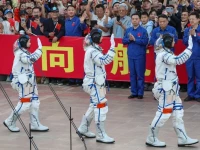 astronauts zhu yangzhu zhang zhiyuan and lai ka ying who is the first astronaut from hong kong wave during a see off ceremony before taking part in the shenzhou 23 spaceflight mission to china s tiangong space station at jiuquan satellite launch center near jiuquan gansu province china may 24 2026 reuters