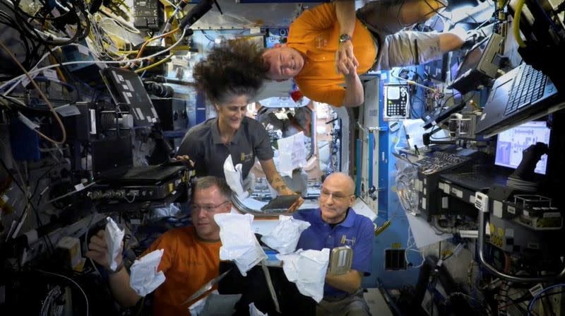 nasa astronauts on iss unbox thanksgiving meals in space photo reuters